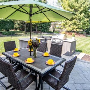 Patio with table set and outdoor kitchen